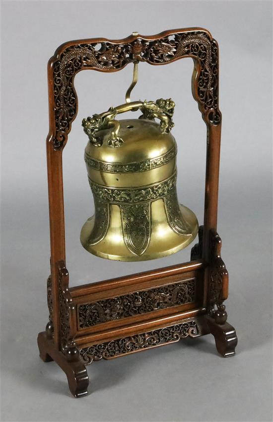 A Chinese Ming bronze bell, 16th/17th century, Height including later wooden dragon stand 73cm